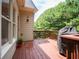 Backyard wooden deck with grill, accessible from the home's exterior at 507 Autumn Walk, Canton, GA 30114