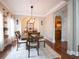 Elegant dining room featuring a wooden table, a stylish light fixture, and hardwood floors at 507 Autumn Walk, Canton, GA 30114