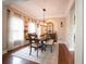 Elegant dining room with hardwood floors, a large dining table, bench seating and a modern chandelier at 507 Autumn Walk, Canton, GA 30114