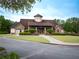 Beautiful community clubhouse with stone and siding accents, well maintained landscaping, and mature trees at 507 Autumn Walk, Canton, GA 30114