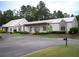 Attractive clubhouse with a modern metal roof, stone accents, and beautiful landscaping at 507 Autumn Walk, Canton, GA 30114