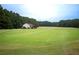 Expansive golf course and putting range with a distant view of a clubhouse at 507 Autumn Walk, Canton, GA 30114