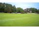 Beautiful golf course featuring a lush green fairway, mature trees, and a glimpse of golf carts at 507 Autumn Walk, Canton, GA 30114