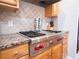 The professional range and tile backsplash highlight the kitchen at 507 Autumn Walk, Canton, GA 30114