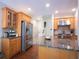 Bright kitchen featuring granite counters, stainless steel appliances, and natural wood cabinets at 507 Autumn Walk, Canton, GA 30114