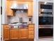 Gourmet kitchen with stainless steel range, tile backsplash, and wood cabinetry at 507 Autumn Walk, Canton, GA 30114
