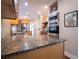 Granite countertops, stainless steel appliances, and wood cabinets accent the kitchen at 507 Autumn Walk, Canton, GA 30114