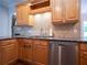 This kitchen has stainless steel appliances, granite countertops, and natural wood cabinets at 507 Autumn Walk, Canton, GA 30114