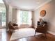 Cozy living room featuring hardwood floors, a large window, two chairs, and an decorative area rug at 507 Autumn Walk, Canton, GA 30114
