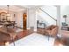 Open living room featuring hardwood floors, two chairs, that opens into the dining room and foyer at 507 Autumn Walk, Canton, GA 30114