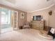 Main bedroom with TV, a cozy chair, a dog bed, and an ensuite bathroom at 507 Autumn Walk, Canton, GA 30114