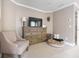 Comfortable main bedroom with a plush chair, TV, dresser, and a cozy pet bed at 507 Autumn Walk, Canton, GA 30114