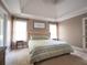 Serene main bedroom with a tray ceiling, a tufted headboard, and plenty of natural light from the windows at 507 Autumn Walk, Canton, GA 30114