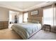 A well-lit main bedroom with a walk-in closet, large windows, and neutral decor at 507 Autumn Walk, Canton, GA 30114