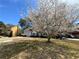 Charming two-story home with brick accents, a two-car garage, and a beautiful flowering tree at 645 Legend Sw Ct, Atlanta, GA 30331