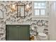 Stylish bathroom featuring patterned wallpaper, a green vanity, and brass fixtures exudes charm at 976 Blue Ridge Ne Ave, Atlanta, GA 30306
