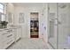 Bright bathroom with a glass shower, tiled floor, and vanity with double sinks, plus walk-in closet access at 976 Blue Ridge Ne Ave, Atlanta, GA 30306