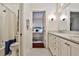 Well-lit bathroom with white cabinetry, marble countertops, and tile flooring provides a clean and modern look at 976 Blue Ridge Ne Ave, Atlanta, GA 30306