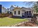 Back of the house with a well-maintained yard, stone pathway, bench, and a private screened-in porch at 976 Blue Ridge Ne Ave, Atlanta, GA 30306