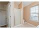 Bathroom featuring a shower and window, offering a refreshing and bright space at 10670 Day Lily Dr, Hampton, GA 30228