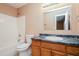 Bathroom featuring a shower-tub combo, vanity, and fixtures at 10670 Day Lily Dr, Hampton, GA 30228