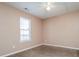 Bedroom featuring a ceiling fan and a window, providing comfort at 10670 Day Lily Dr, Hampton, GA 30228
