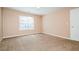 Carpeted bedroom features natural light from window and a convenient closet at 10670 Day Lily Dr, Hampton, GA 30228