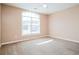 Bright, carpeted bedroom featuring a large window and neutral paint at 10670 Day Lily Dr, Hampton, GA 30228