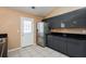 Stylish kitchen showcasing dark cabinets, stainless steel refrigerator, and modern tile floors at 10670 Day Lily Dr, Hampton, GA 30228
