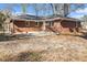 Back exterior of brick home with a concrete patio and spacious yard at 1207 Ellington Dr, Morrow, GA 30260