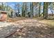 Home's backyard with large concrete patio and a sizeable lot at 1207 Ellington Dr, Morrow, GA 30260