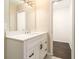 This bathroom features a modern vanity with a white countertop and black accents at 1207 Ellington Dr, Morrow, GA 30260