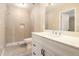 This bathroom features a tiled walk-in shower and a white vanity with a quartz countertop at 1207 Ellington Dr, Morrow, GA 30260