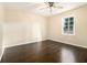 This bedroom features hardwood floors and a bright window with neutral-colored walls at 1207 Ellington Dr, Morrow, GA 30260