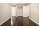This bedroom features dark hardwood floors and neutral walls with bright white trim and baseboards at 1207 Ellington Dr, Morrow, GA 30260