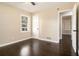 This bedroom features hardwood floors, a bright window, and white trim at 1207 Ellington Dr, Morrow, GA 30260