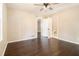 This bedroom features hardwood floors, a bright window, and a ceiling fan at 1207 Ellington Dr, Morrow, GA 30260