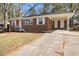 Picture of a cozy brick home featuring a carport, a walkway, and a well-maintained lawn at 1207 Ellington Dr, Morrow, GA 30260