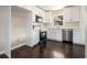 Modern kitchen with white cabinets, stainless steel appliances, and dark hardwood floors at 1207 Ellington Dr, Morrow, GA 30260