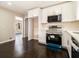 Well-lit kitchen featuring white cabinetry, stainless appliances, and an open view to the next room at 1207 Ellington Dr, Morrow, GA 30260