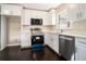 Bright kitchen with white cabinets, quartz countertops, and stainless steel appliances at 1207 Ellington Dr, Morrow, GA 30260