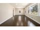 Spacious living room with polished hardwood floors, bright windows, and neutral wall color at 1207 Ellington Dr, Morrow, GA 30260