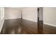 Expansive living area showcasing hardwood floors, neutral decor, and open doorway to another room at 1207 Ellington Dr, Morrow, GA 30260