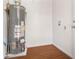 A well lit utility room features wood look flooring and a tank water heater at 1207 Ellington Dr, Morrow, GA 30260