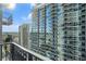 Stunning condo balcony view of the city skyline, featuring modern high-rise buildings with reflective glass and outdoor seating at 195 14Th Ne St # 1908, Atlanta, GA 30309