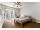 Bright bedroom with hardwood floors, ceiling fan, and sliding glass doors to the balcony at 195 14Th Ne St # 1908, Atlanta, GA 30309