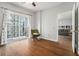 View of the bedroom with balcony, hardwood floors, and gray walls at 195 14Th Ne St # 1908, Atlanta, GA 30309
