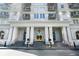 Grand building entrance with columns and stairs leading to the gold-trimmed doors at 195 14Th Ne St # 1908, Atlanta, GA 30309