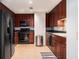 Well-equipped kitchen with dark cabinets, stainless steel appliances, and tile flooring at 195 14Th Ne St # 1908, Atlanta, GA 30309