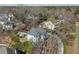 An aerial view showing a home with an in-ground pool, set amongst lush greenery in a peaceful neighborhood at 10660 Thatcher Way, Johns Creek, GA 30097